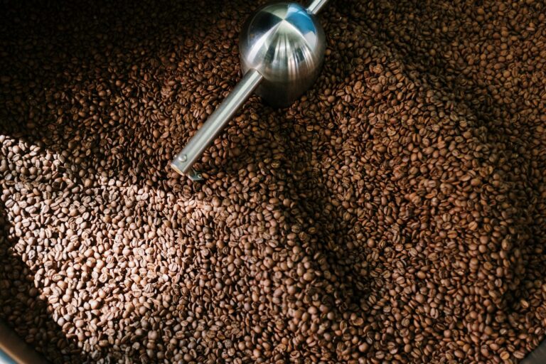 Detailed image of roasted coffee beans spinning inside a professional coffee roaster.